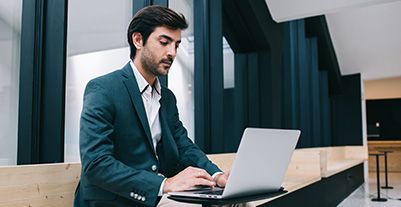 Man using a laptop serious looking