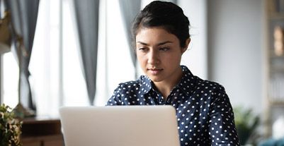 Young woman using a laptop phone