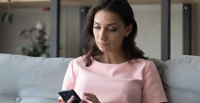 Young woman using a laptop phone