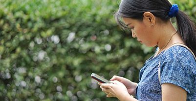 Young woman using a laptop phone